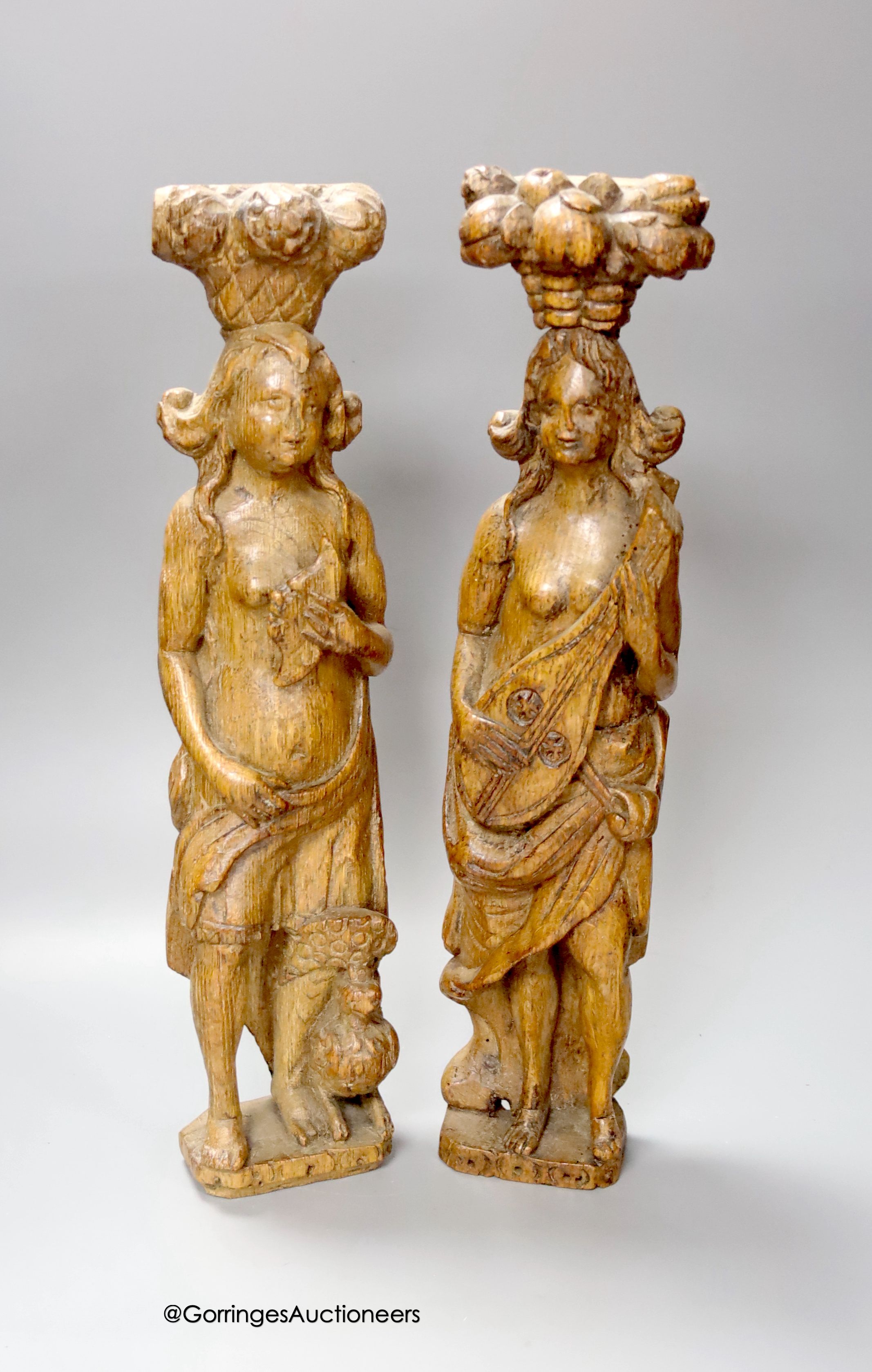 A pair of 17th century carved oak figures 41cm